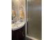 Bathroom showcasing a vanity with sink, mirror, and a glass-enclosed shower at 57 Harbor Way # 24, Palm Harbor, FL 34684