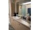 Bathroom with a sink, vanity, and ample counter space, reflected in a large mirror at 57 Harbor Way # 24, Palm Harbor, FL 34684