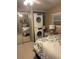 Bedroom featuring a stacked washer/dryer, and mirrored closet doors at 57 Harbor Way # 24, Palm Harbor, FL 34684