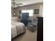 Cozy bedroom with a ceiling fan, television, recliner and natural light from the window at 57 Harbor Way # 24, Palm Harbor, FL 34684