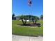 Charming single-story home with an American flag, palm trees, pink flamingos, and well-manicured lawn at 57 Harbor Way # 24, Palm Harbor, FL 34684