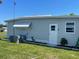 Side view of home, showcasing well-maintained exterior and lush green surroundings at 57 Harbor Way # 24, Palm Harbor, FL 34684