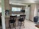 Bright kitchen with stainless steel appliances, tile flooring, and breakfast bar at 57 Harbor Way # 24, Palm Harbor, FL 34684
