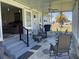 Inviting screened porch featuring ample seating and outdoor dining space at 57 Harbor Way # 24, Palm Harbor, FL 34684