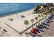 Aerial view of a well-maintained beach with parking, palm trees, and recreational facilities at 5940 30Th S Ave # 206, Gulfport, FL 33707