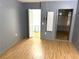 Bedroom featuring practical flooring, neutral walls, closet, and sliding glass doors for convenient access and style at 5940 30Th S Ave # 206, Gulfport, FL 33707