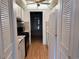 This galley kitchen offers modern appliances, complemented by laminate floors, and direct sightlines to the living area at 5940 30Th S Ave # 206, Gulfport, FL 33707