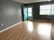 Bright living room boasting stylish flooring, neutral walls, bright natural light, and a charming blue door at 5940 30Th S Ave # 206, Gulfport, FL 33707