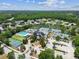 Aerial view of community with pool, tennis courts, lush landscaping at 6006 Chellas Ct, Lutz, FL 33558