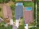Aerial view of three homes, each with screened-in pools and well-maintained landscaping at 6006 Chellas Ct, Lutz, FL 33558