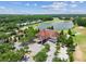 An aerial view of the A Tavern at Cheval restaurant located beside a lake and golf course at 6006 Chellas Ct, Lutz, FL 33558