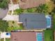 An aerial view shows a private backyard with a pool in a screened enclosure and a manicured lawn with mature landscaping at 6006 Chellas Ct, Lutz, FL 33558