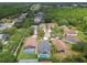 Aerial view of the neighborhood with houses and trees near a highway and a small lake at 6006 Chellas Ct, Lutz, FL 33558