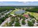 An aerial view of A Tavern at Cheval near lake and golf course with a parking lot at 6006 Chellas Ct, Lutz, FL 33558
