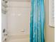 Bathroom displaying a tub with a showerhead and a blue curtain at 6006 Chellas Ct, Lutz, FL 33558