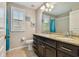 Bathroom featuring double sinks, granite counters, and neutral walls at 6006 Chellas Ct, Lutz, FL 33558