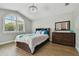 Bright bedroom with an arched window, wood-look tile floors, and decorative accents at 6006 Chellas Ct, Lutz, FL 33558