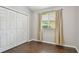 Bedroom showcasing laminate wood flooring, natural lighting, and closet at 6006 Chellas Ct, Lutz, FL 33558