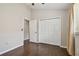 Bedroom displaying laminate flooring, closet, and view of the doorway at 6006 Chellas Ct, Lutz, FL 33558