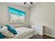 Bedroom with a bed, white dresser, hardwood floors, and natural light at 6006 Chellas Ct, Lutz, FL 33558