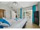 Bedroom offers outdoor kitchen view, wood-look tile floors, and patio access at 6006 Chellas Ct, Lutz, FL 33558