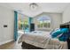 Bedroom features pool view, patio access, arched window, and wood-look tile flooring at 6006 Chellas Ct, Lutz, FL 33558