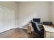 Bedroom with laminate wood flooring, a closet, and a desk at 6006 Chellas Ct, Lutz, FL 33558