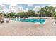 Well-maintained community pool with lap lanes and brick pool deck at 6006 Chellas Ct, Lutz, FL 33558