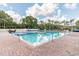 Community pool with in-ground hot tub, brick pool deck and lounge seating at 6006 Chellas Ct, Lutz, FL 33558
