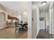 A dining area with a wood table and chairs, hardwood floors and a view of the kitchen in the background at 6006 Chellas Ct, Lutz, FL 33558