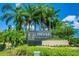 A welcoming Cheval Golf and Country Club entrance with palm trees and lush landscaping at 6006 Chellas Ct, Lutz, FL 33558