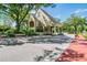 Classic entrance gatehouse to a community with brick-paved drive and lush landscaping at 6006 Chellas Ct, Lutz, FL 33558