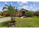 Charming single-story home with a well-manicured lawn and lush landscaping and two-car garage at 6006 Chellas Ct, Lutz, FL 33558