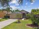 Charming single-story home with a well-manicured lawn and lush landscaping and two-car garage at 6006 Chellas Ct, Lutz, FL 33558