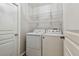 Laundry room with a washing machine, dryer and wire shelving at 6006 Chellas Ct, Lutz, FL 33558