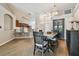 Open-concept floor plan with wood floors connecting the kitchen, dining area, and front entryway at 6006 Chellas Ct, Lutz, FL 33558