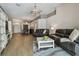 Open-concept living room offers wood floors and combines living, dining, and entryway spaces for seamless living at 6006 Chellas Ct, Lutz, FL 33558
