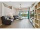 Bright living room with tile floors, a chandelier, sliding glass doors leading to the pool, and comfortable seating at 6006 Chellas Ct, Lutz, FL 33558