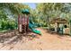 A view of a playground with a climbing structure, slide, and mulch ground covering at 6006 Chellas Ct, Lutz, FL 33558