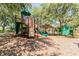 View of playground with climbing structure, slide, activity walls, picnic shelter, and mulch ground cover at 6006 Chellas Ct, Lutz, FL 33558