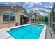 The screened pool area offers ample space and great backyard views and provides an ideal spot for relaxation and outdoor activities at 6006 Chellas Ct, Lutz, FL 33558