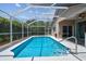 Enjoy the screened pool with its clear blue water, adjacent to a sliding glass door, providing easy indoor/outdoor living at 6006 Chellas Ct, Lutz, FL 33558