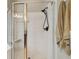 Bright bathroom showcasing a shower with glass doors and a matte black shower head fixture at 6006 Chellas Ct, Lutz, FL 33558