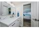 Bright bathroom with white vanity, marble countertop, and modern fixtures, next to bedroom at 6265 Sun Blvd # 115, St Petersburg, FL 33715