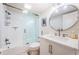 Updated bathroom with glass enclosed tub and shower, modern vanity and lighting at 6265 Sun Blvd # 115, St Petersburg, FL 33715