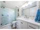 Bathroom featuring a glass door shower and vanity with quartz countertop at 6265 Sun Blvd # 115, St Petersburg, FL 33715