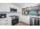 Modern kitchen with stainless steel appliances, white cabinetry and countertop at 6265 Sun Blvd # 115, St Petersburg, FL 33715