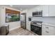 Modern kitchen with stainless steel appliances, white cabinetry, and bright natural lighting at 6265 Sun Blvd # 115, St Petersburg, FL 33715