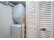 Convenient laundry area featuring a stacked washer and dryer with storage space at 6265 Sun Blvd # 115, St Petersburg, FL 33715