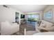 Inviting living room with comfortable seating and sliding glass doors to outdoor patio with beach view at 6265 Sun Blvd # 115, St Petersburg, FL 33715